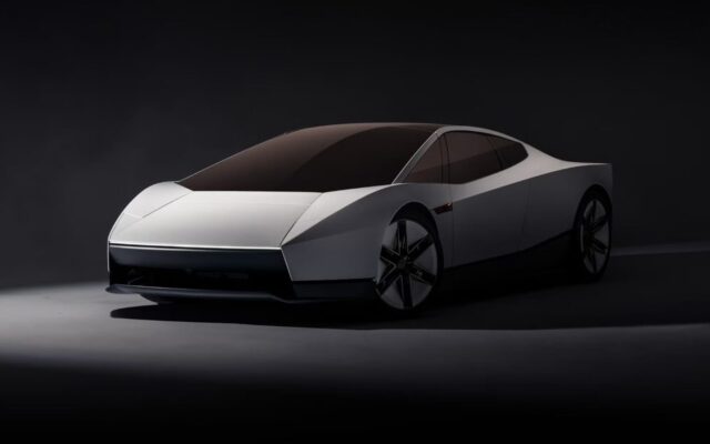 White second-generation Tesla Roadster front three-quarter view in a dark studio