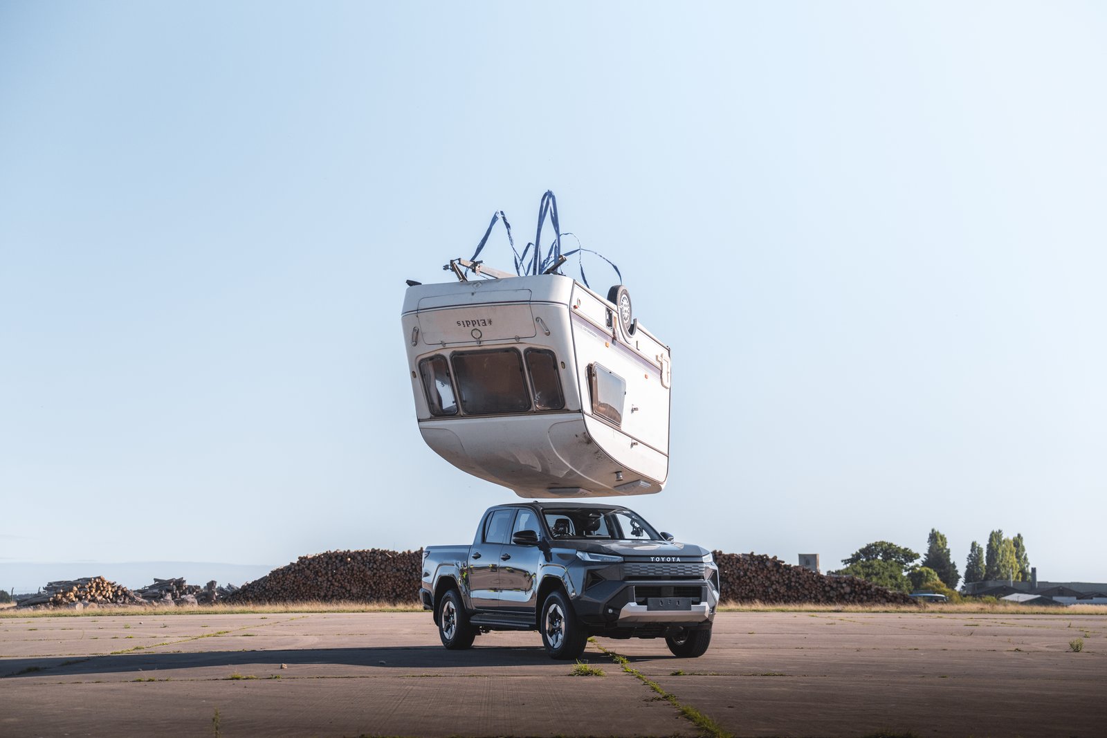 Caravan falling towards a Toyota Hilux BEV
