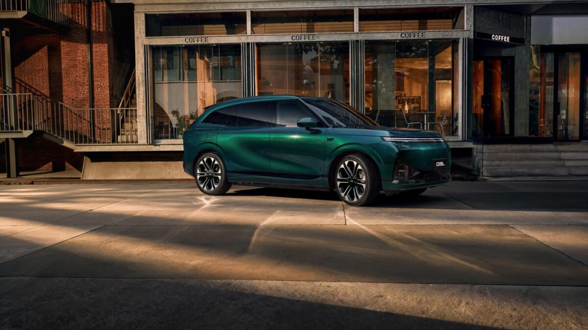 Green XPeng G9L parked outside a building