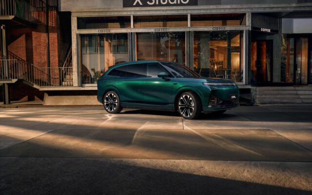Green XPeng G9L parked outside a building