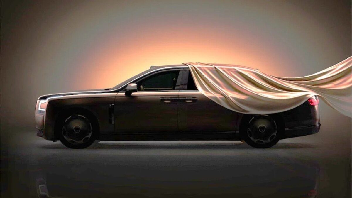 Yangwang Altior luxury sedan teaser image in profile, partly covered by a silk sheet