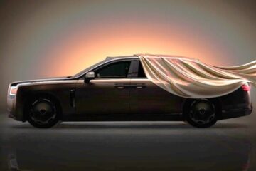 Yangwang Altior luxury sedan teaser image in profile, partly covered by a silk sheet