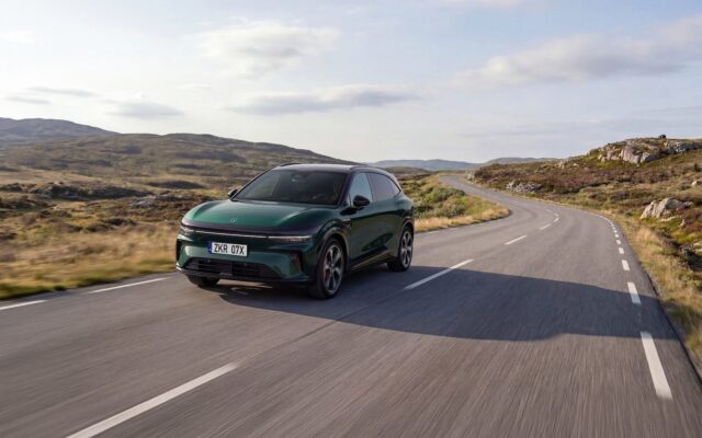Green updated Zeekr 7X driving on a coastal mountain road